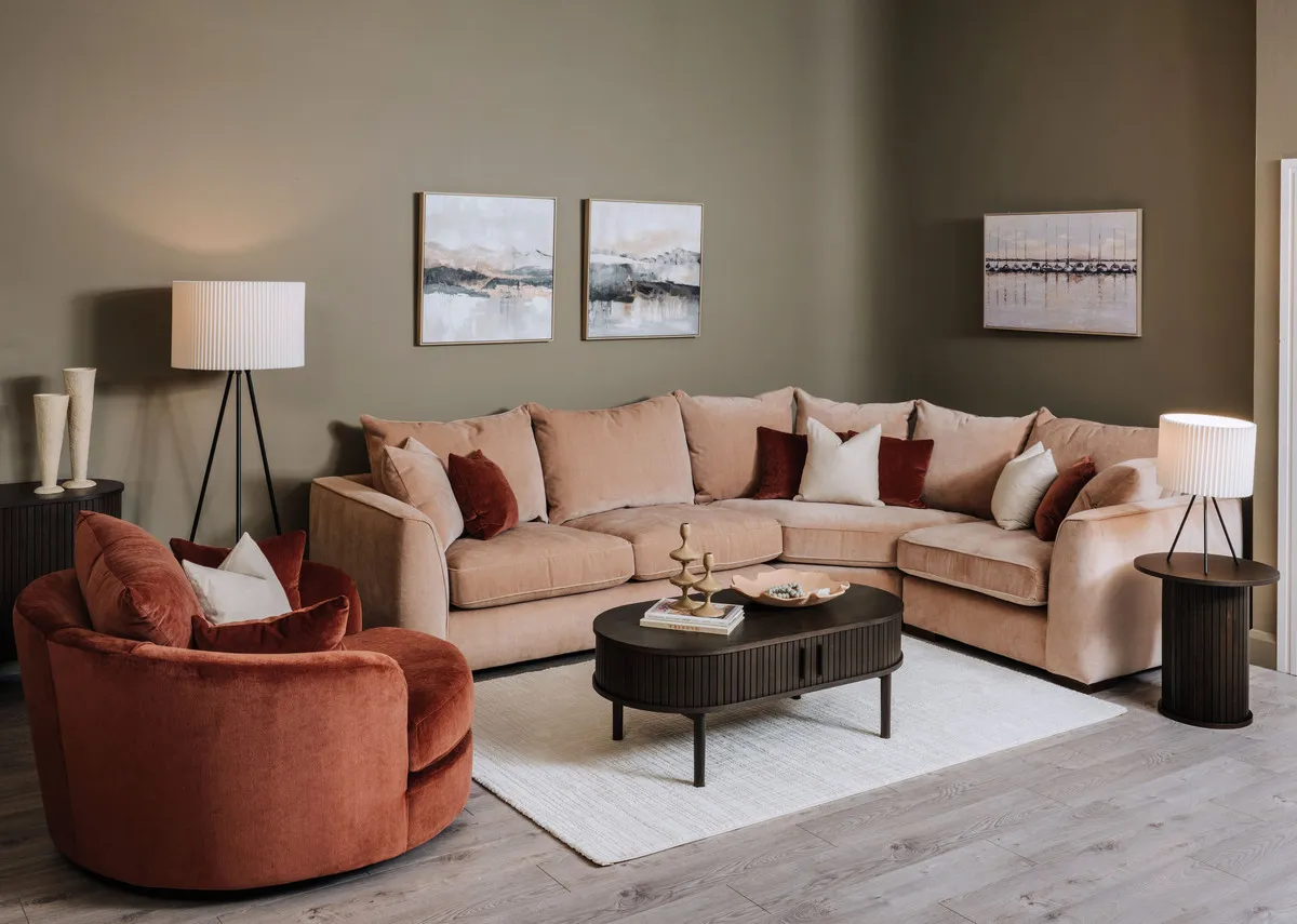 A lifestyle image of the Lucius corner sofa with cuddler and Sign rug.