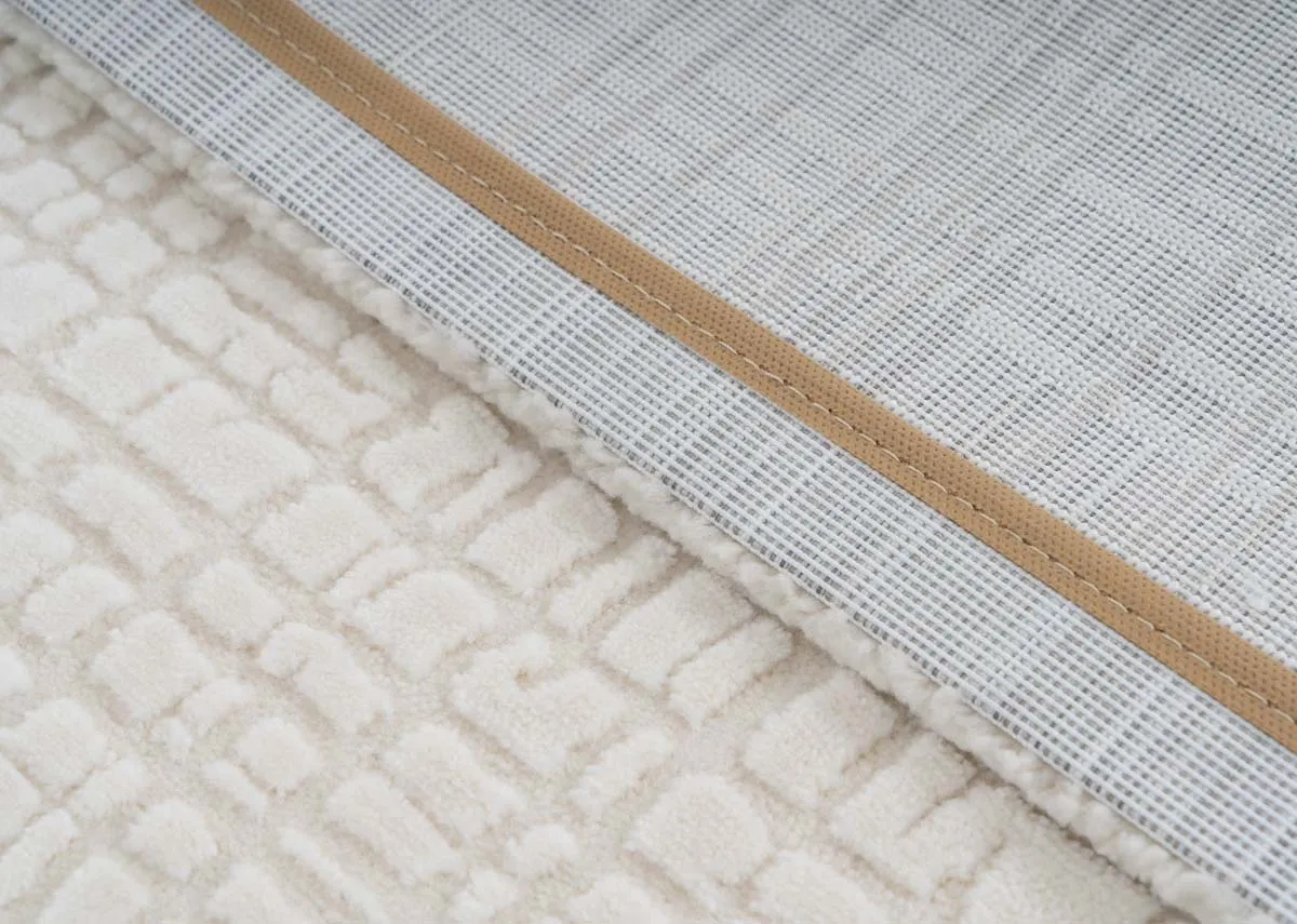 A large cream textured rug from EZ Livings Sign range.Closeup of texture