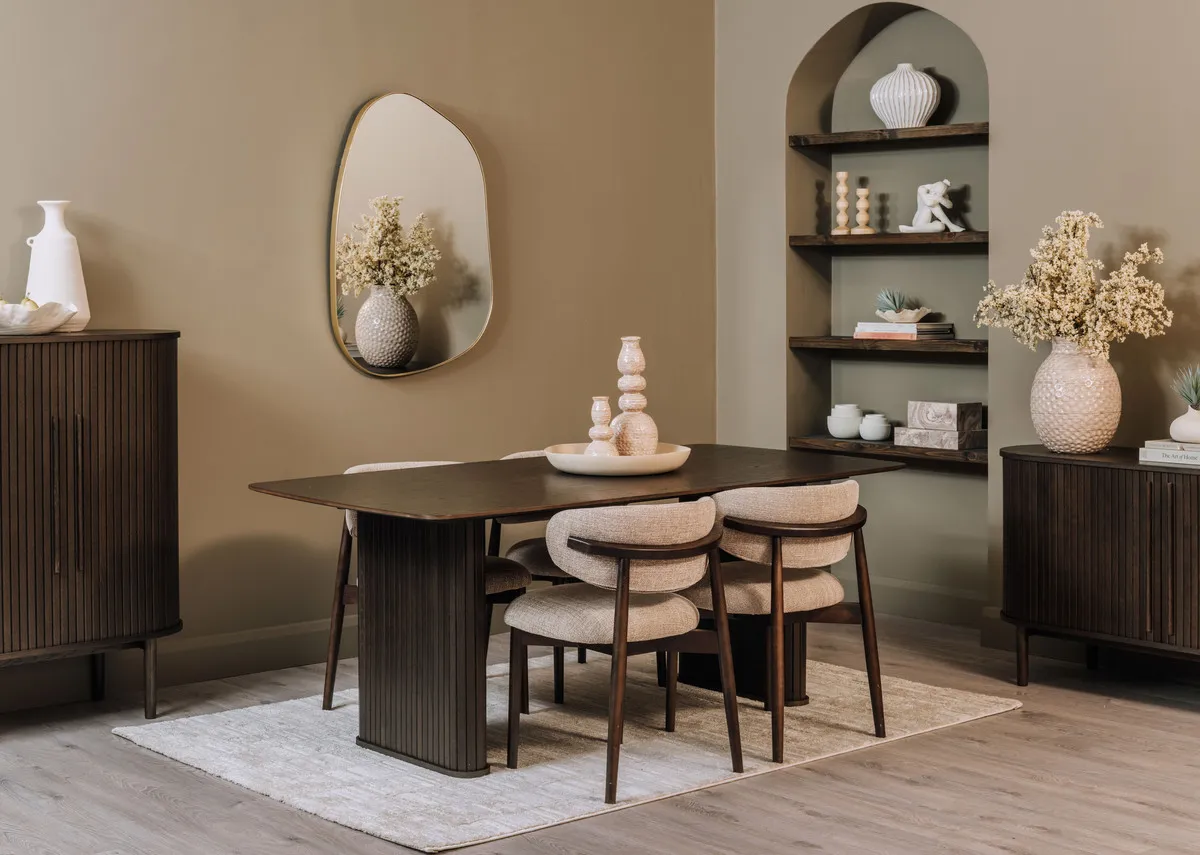 A lifestyle image of the Nola rectangular dining table with sideboard and cabinet with Sable rug.