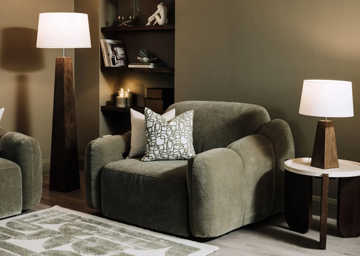 A lifestyle image of the Eleanor green armchair with kira tables and Fauna lamps.