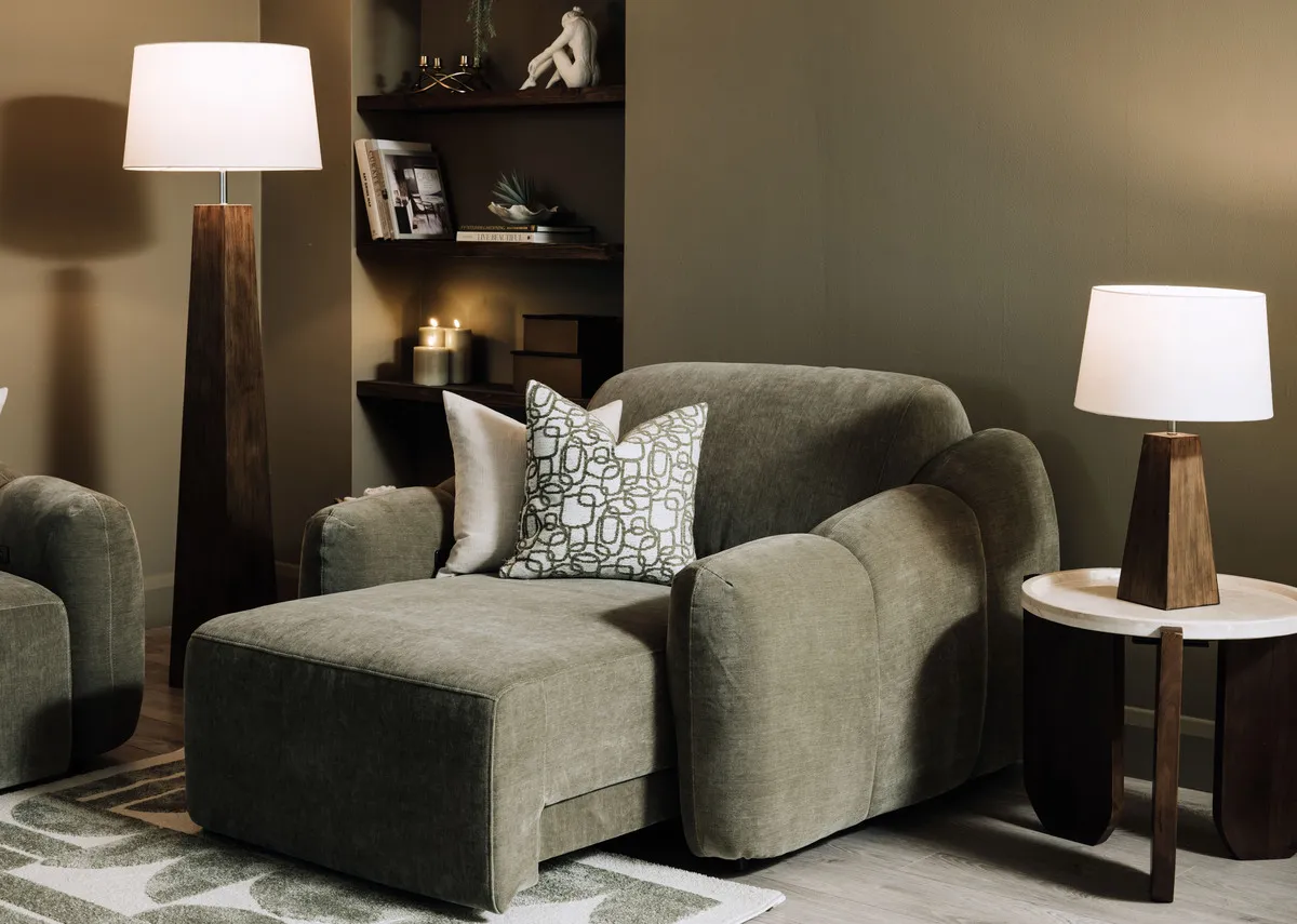 A lifestyle image of the Eleanor green armchair as a chaise with kira tables and Fauna lamps.
