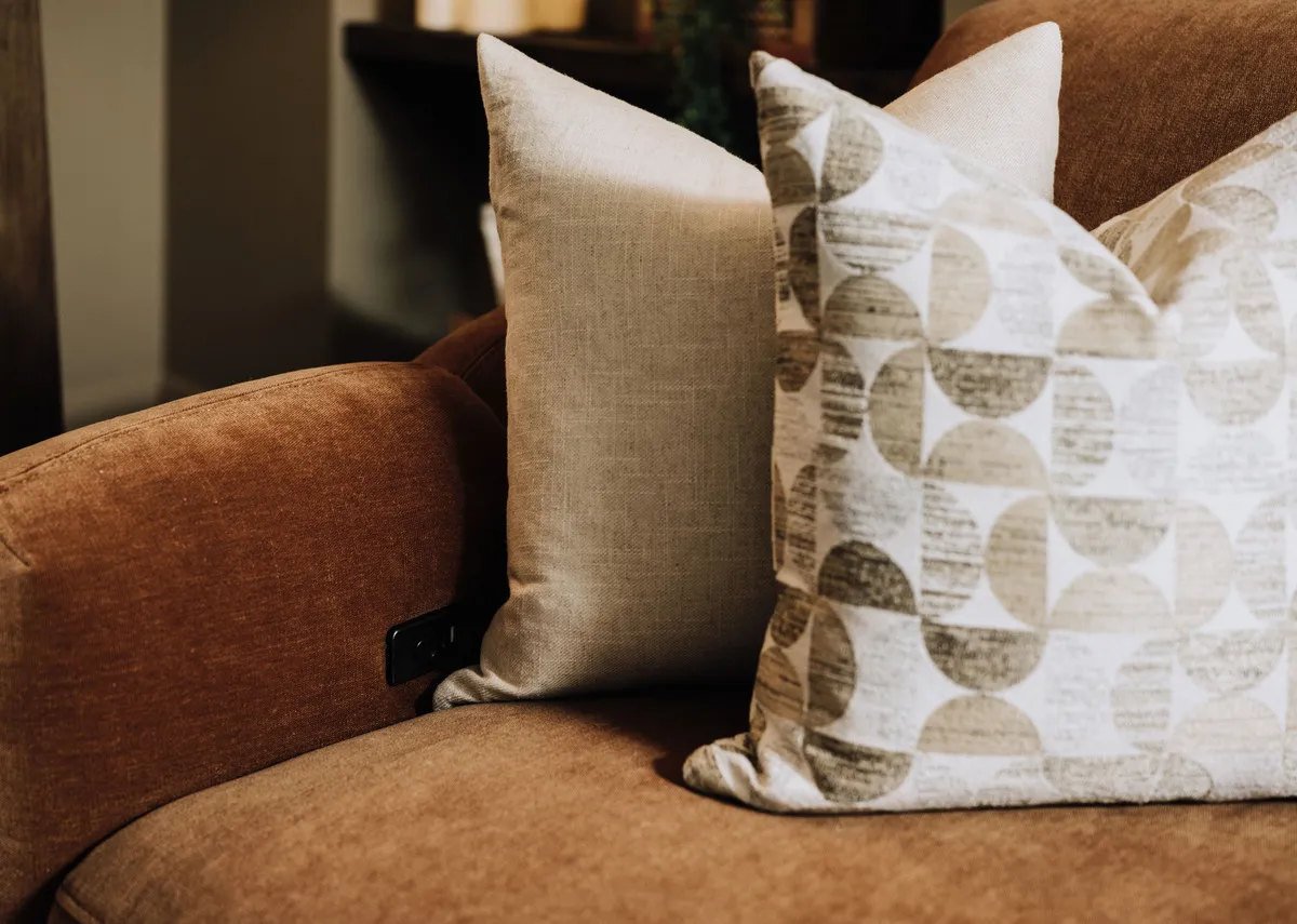 A closeup lifestyle image of the Eleanor rust armchair to show the inside of the armrest control pad