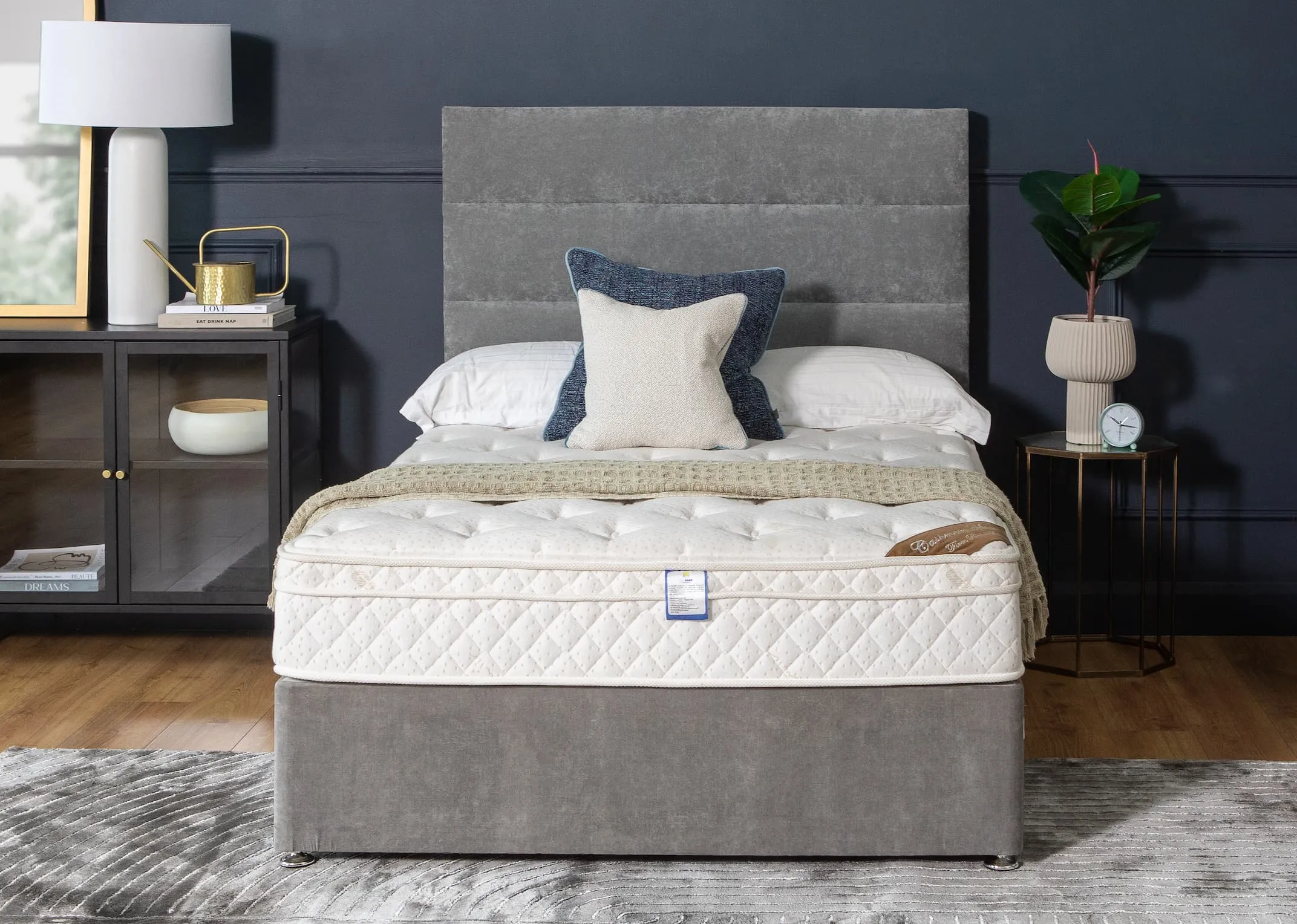 A lifestyle image of the Majesty Cashmere Mattress on the Venice divan with Octagon side table & Saturn lamp.