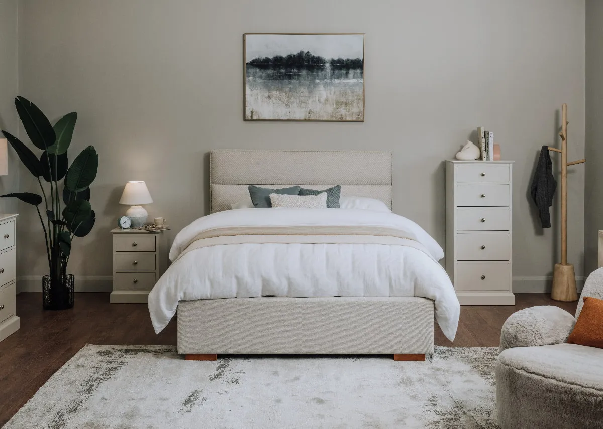 A lifestyle image of the Ebony bed with rivendale locker & chest in a bedroom setting with kylo rug.