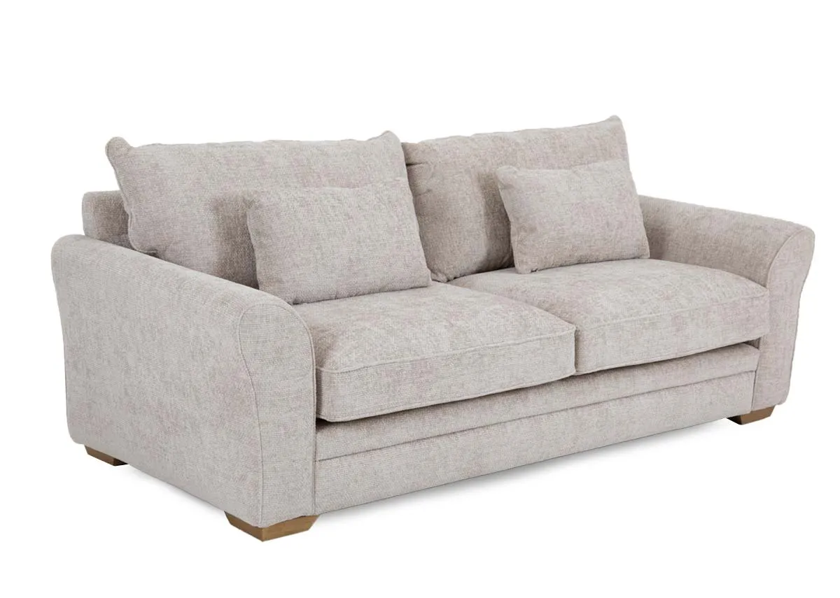 A 3 seater beige fabric sofa from EZ Livings Skyline range. Angled view of wood feet and 2 side cushions.