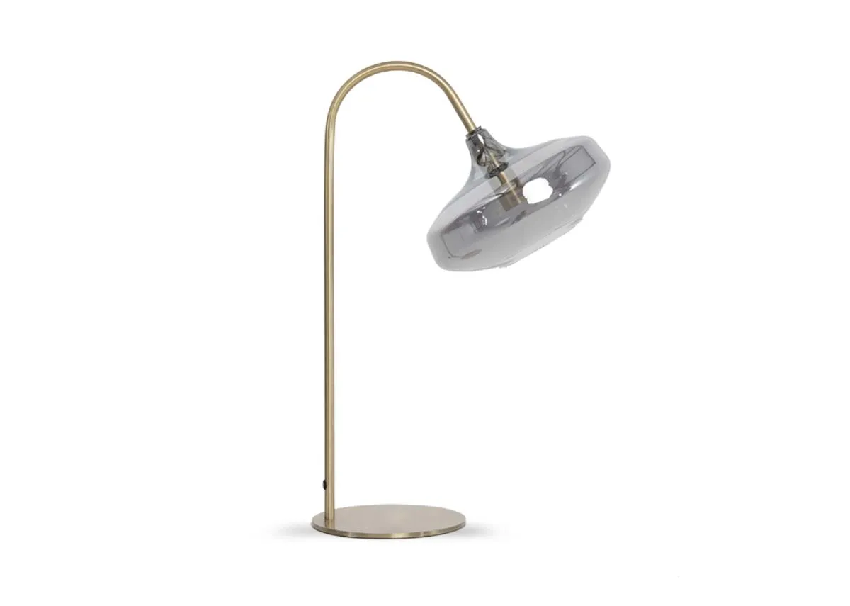 A gold table lamp with a smokey grey glass shade from EZ Livings Alisha.