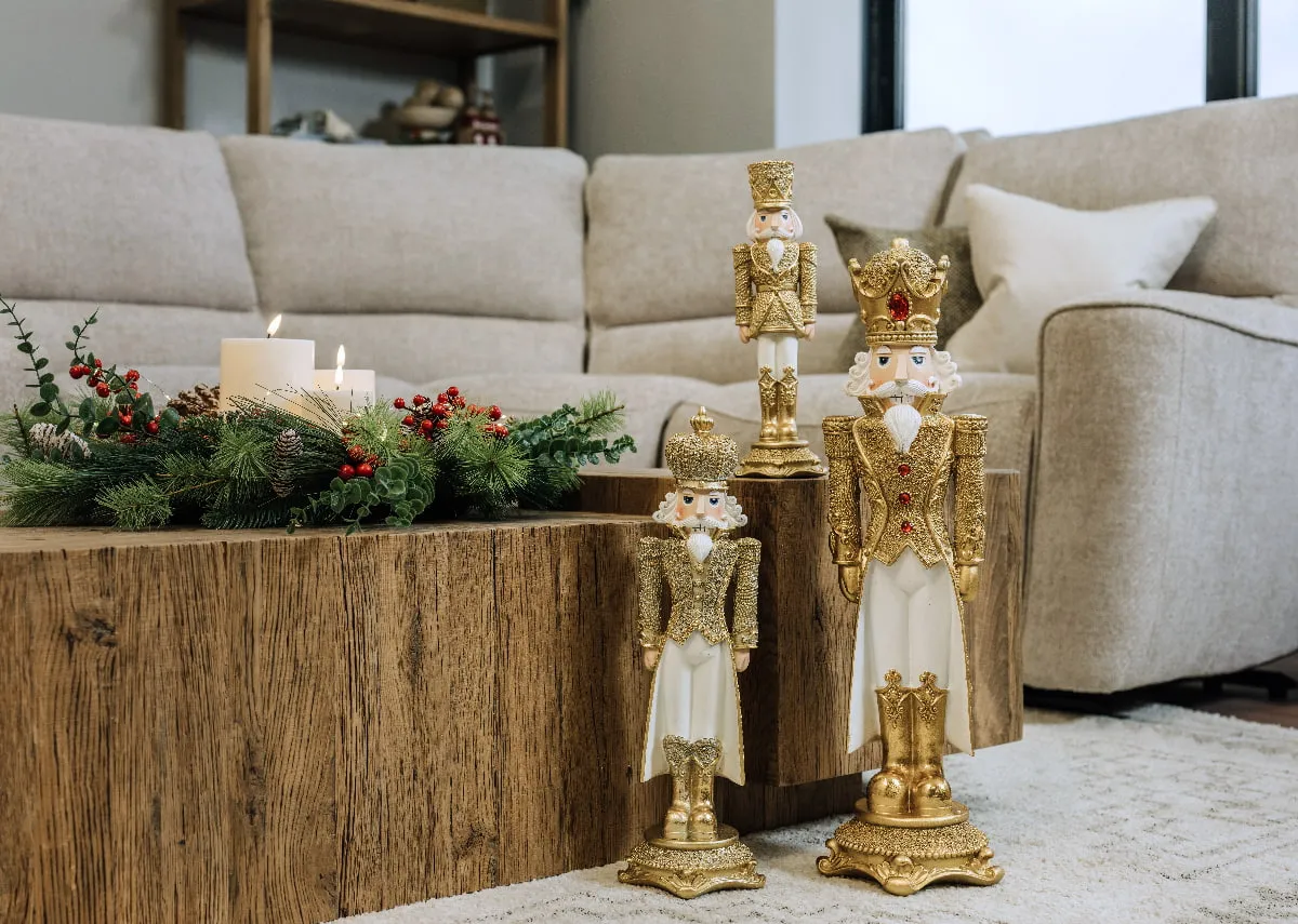A lifetsyle image of the Nova coffee table with a selection of gold nutcracker ornaments including King Lir