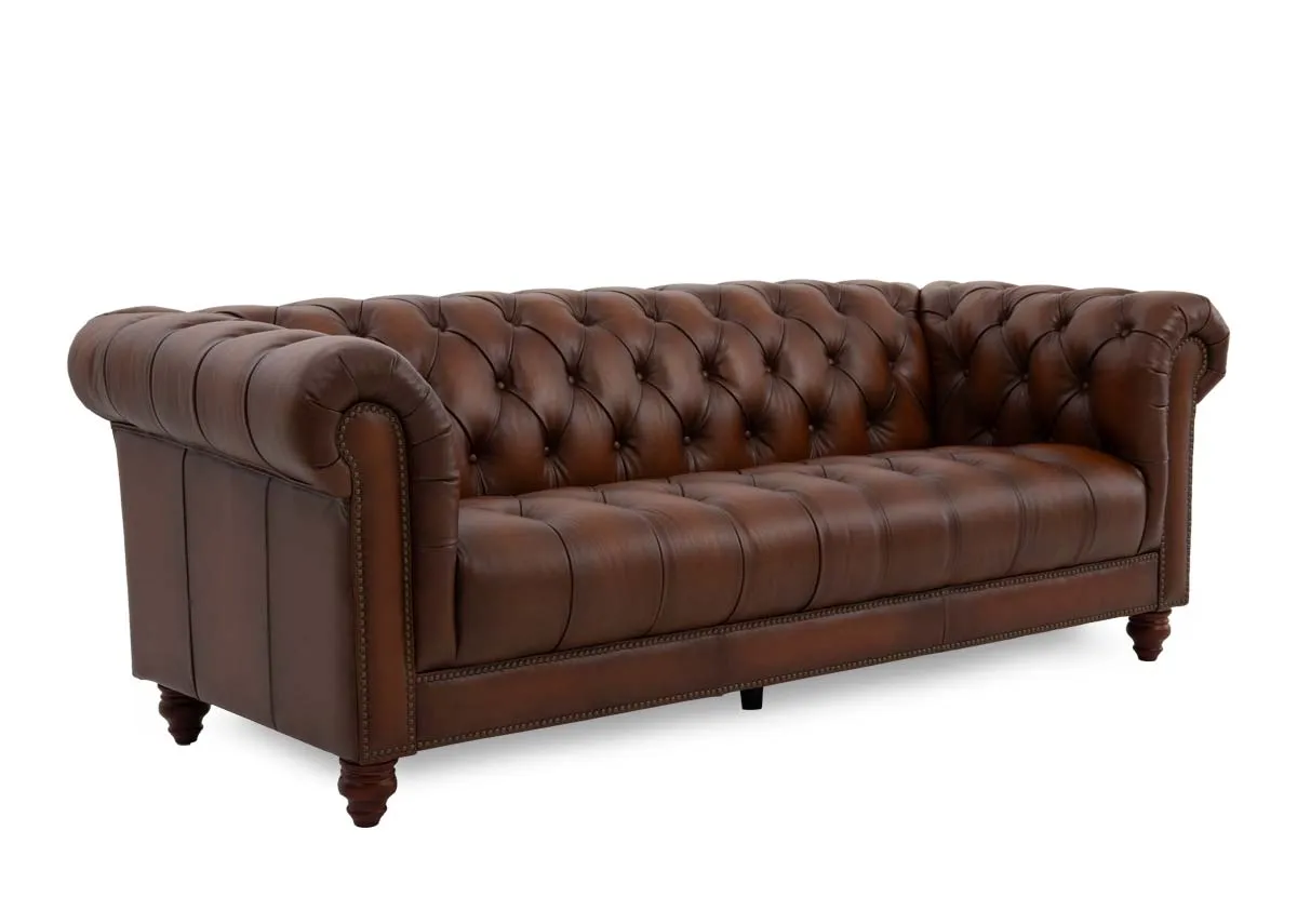 A 3.5 seater roll back brown leather sofa from EZ Livings Adare range. Anglew view of button back detail.