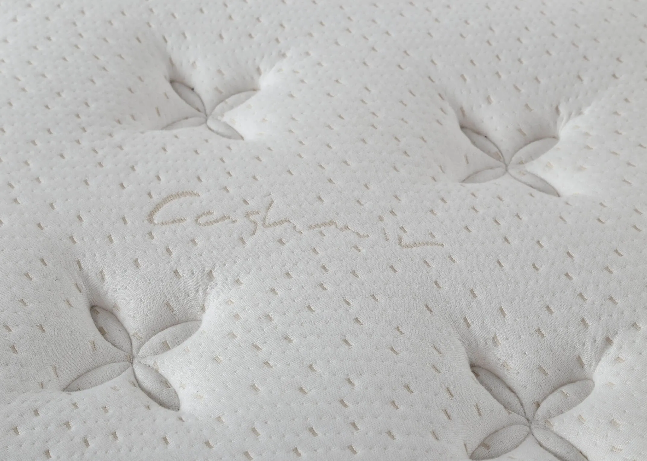 A side view of the Majesty Cashmere  4 foot 6 mattress on a bed frame.