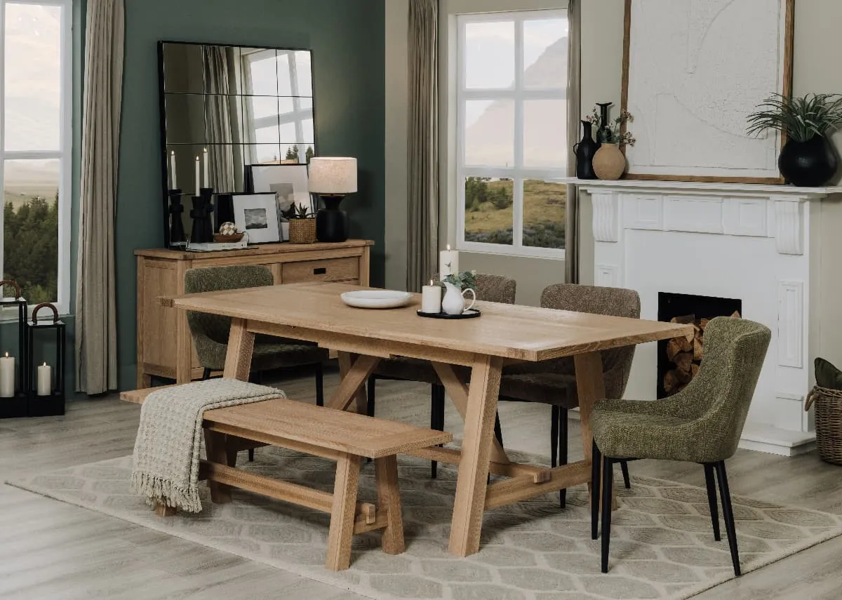 A lifestyle image of the Albany dining table extended & bench with Dylan chairs in green and Albany sideboard.