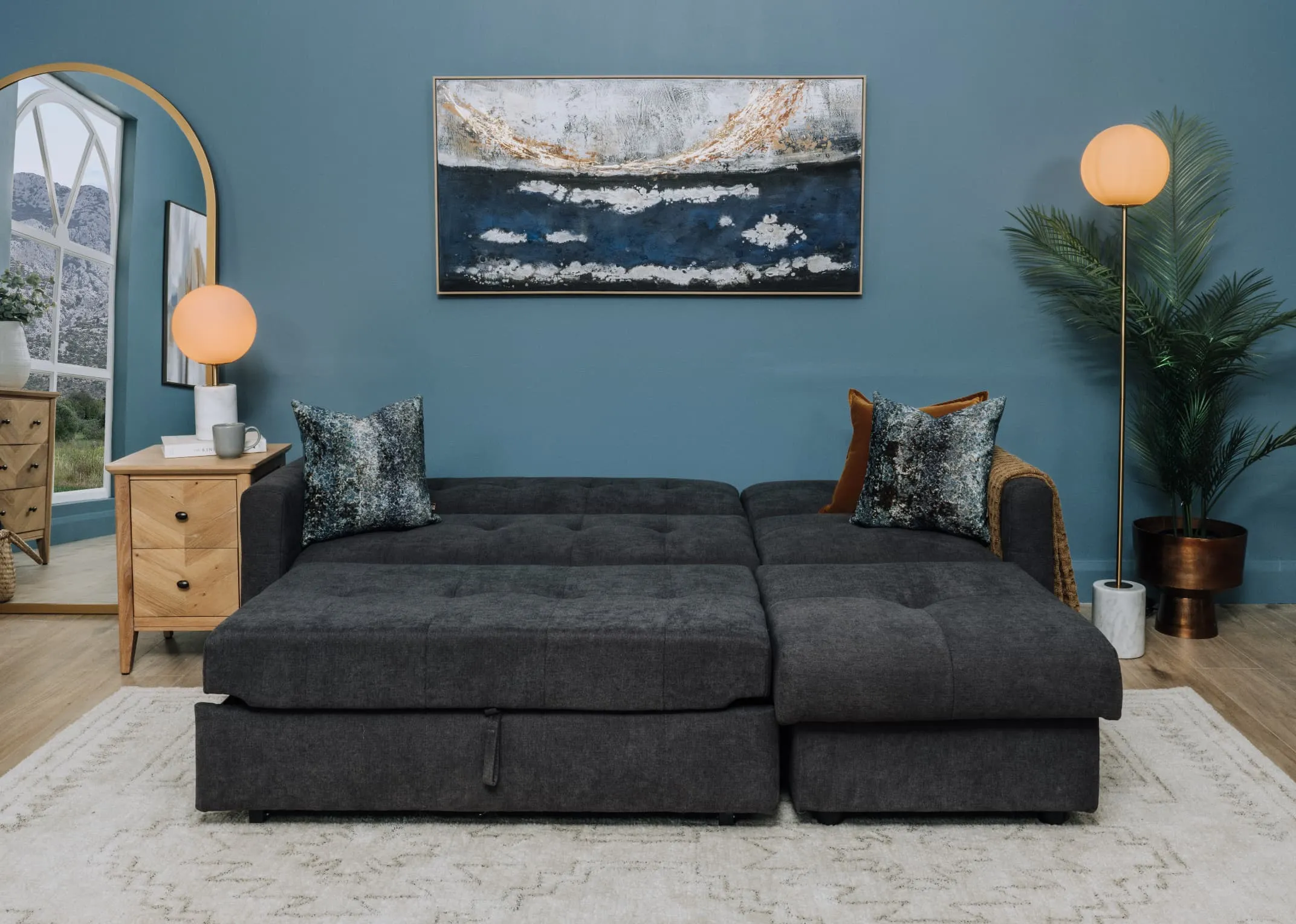 A lifetsyle image of the Dalkey sofabed as a bed with chevron side locker and Captivating canvas.