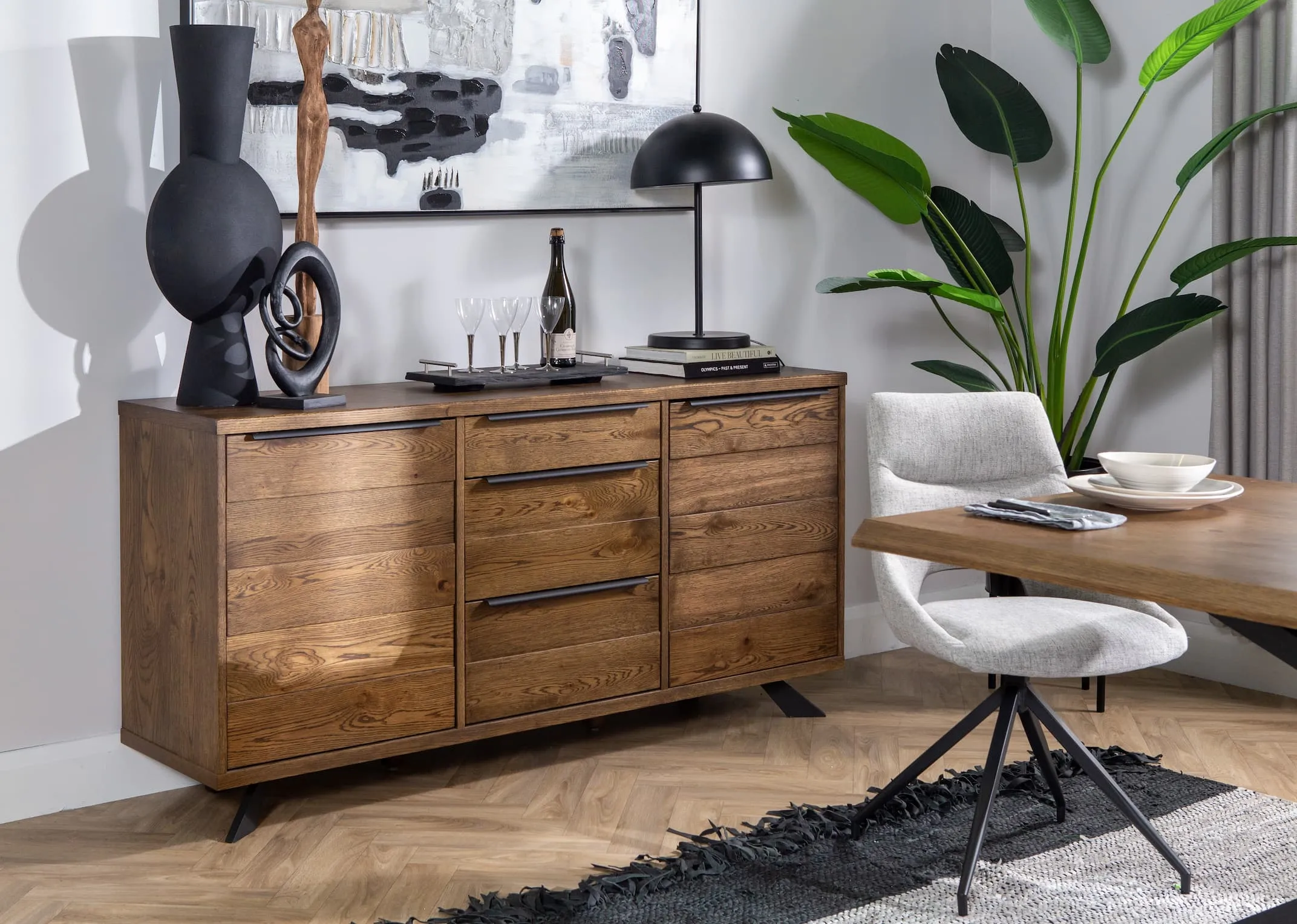 A lifestyle image of the Arno smoked oak sideboard with katopa ornament