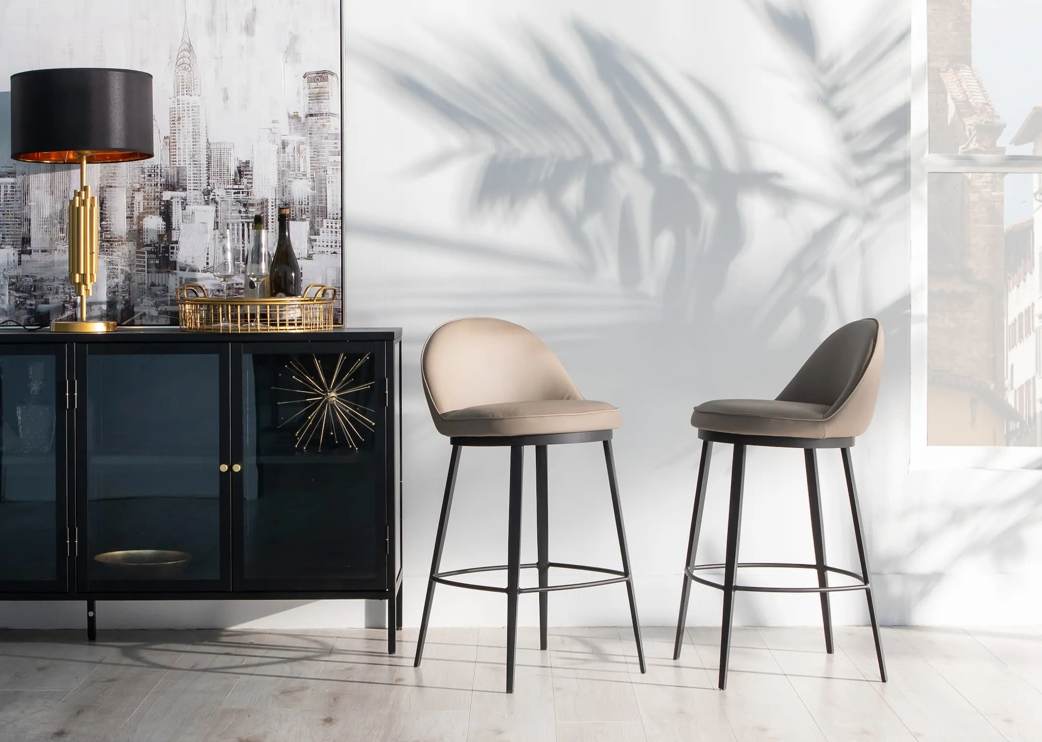 A lifestyle image of two Gain counter stools with the carmel sideboard and Jasper lamp