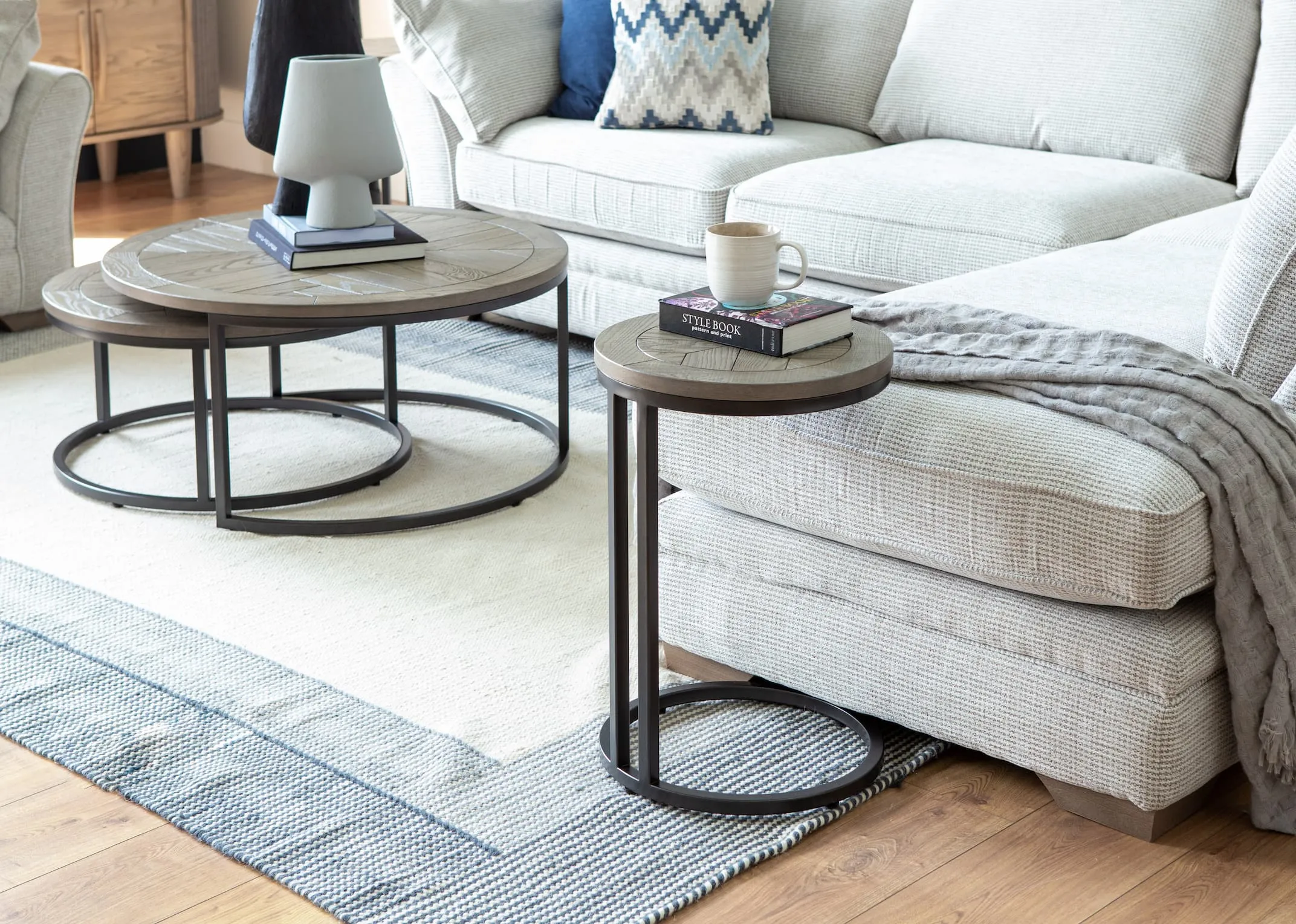 A lifestyle image of the Strata sofa with Monroe sofa table & nest of coffee tables from EZ Living Furniture