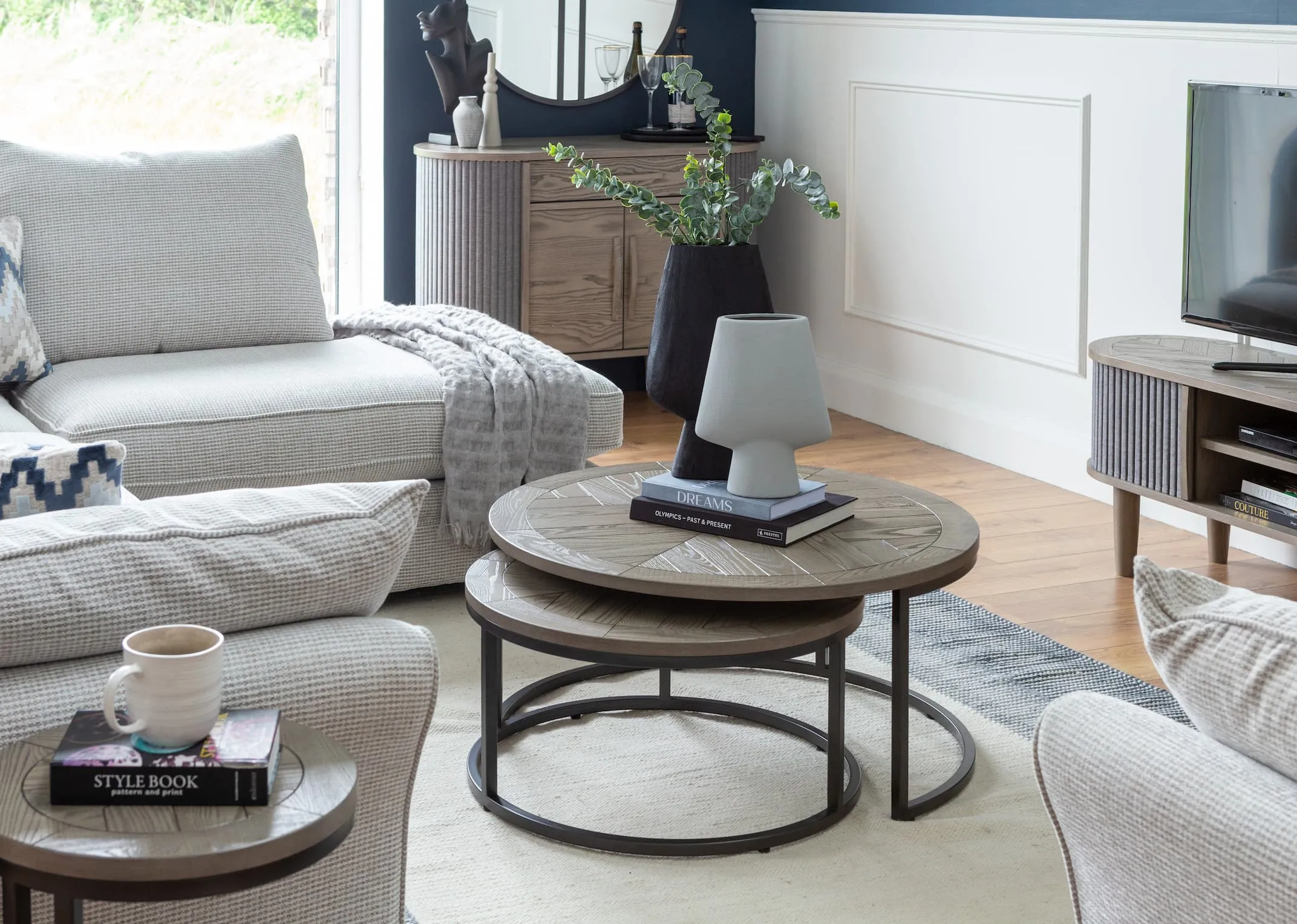 A lifestyle image of the Strata sofa with Monroe nest of coffee tables from EZ Living Furniture