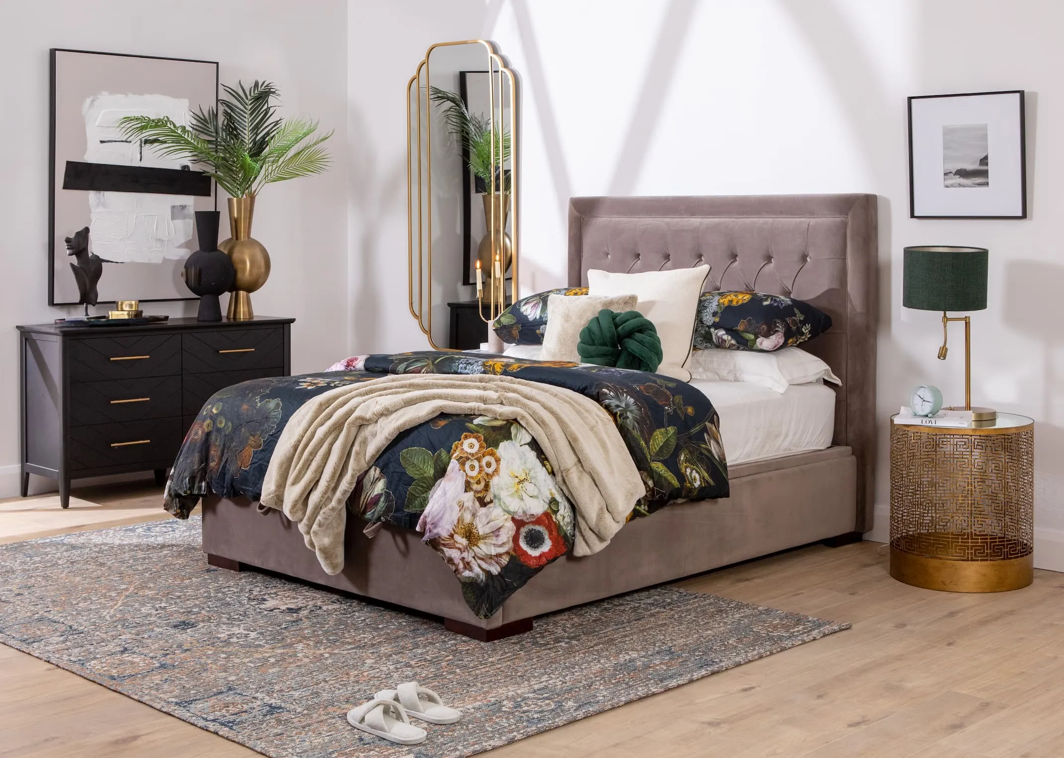 A lifestyle image of the Majestic taupe bed open to reveal under bed storage and chevron black chest of drawers