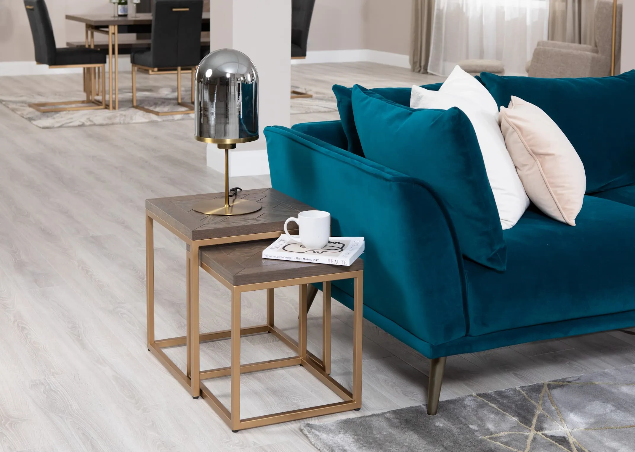 A lifestyle image of the Katie teal sofa range with Greenwich nest of tables with Lotta lamp.
