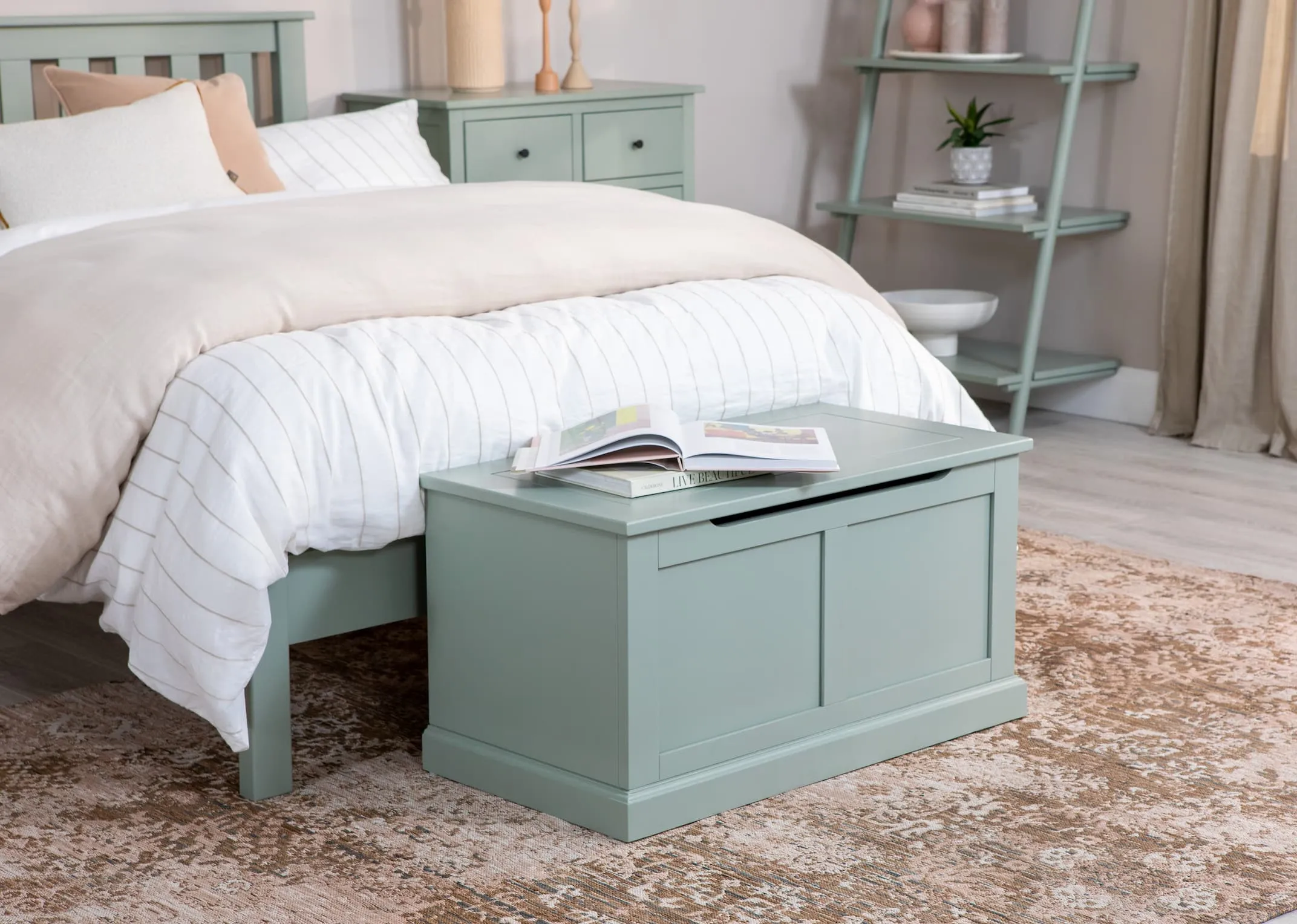 A lifetsyle image of the Atlas green bedroom range with blanket box closed at the foot of the bed.
