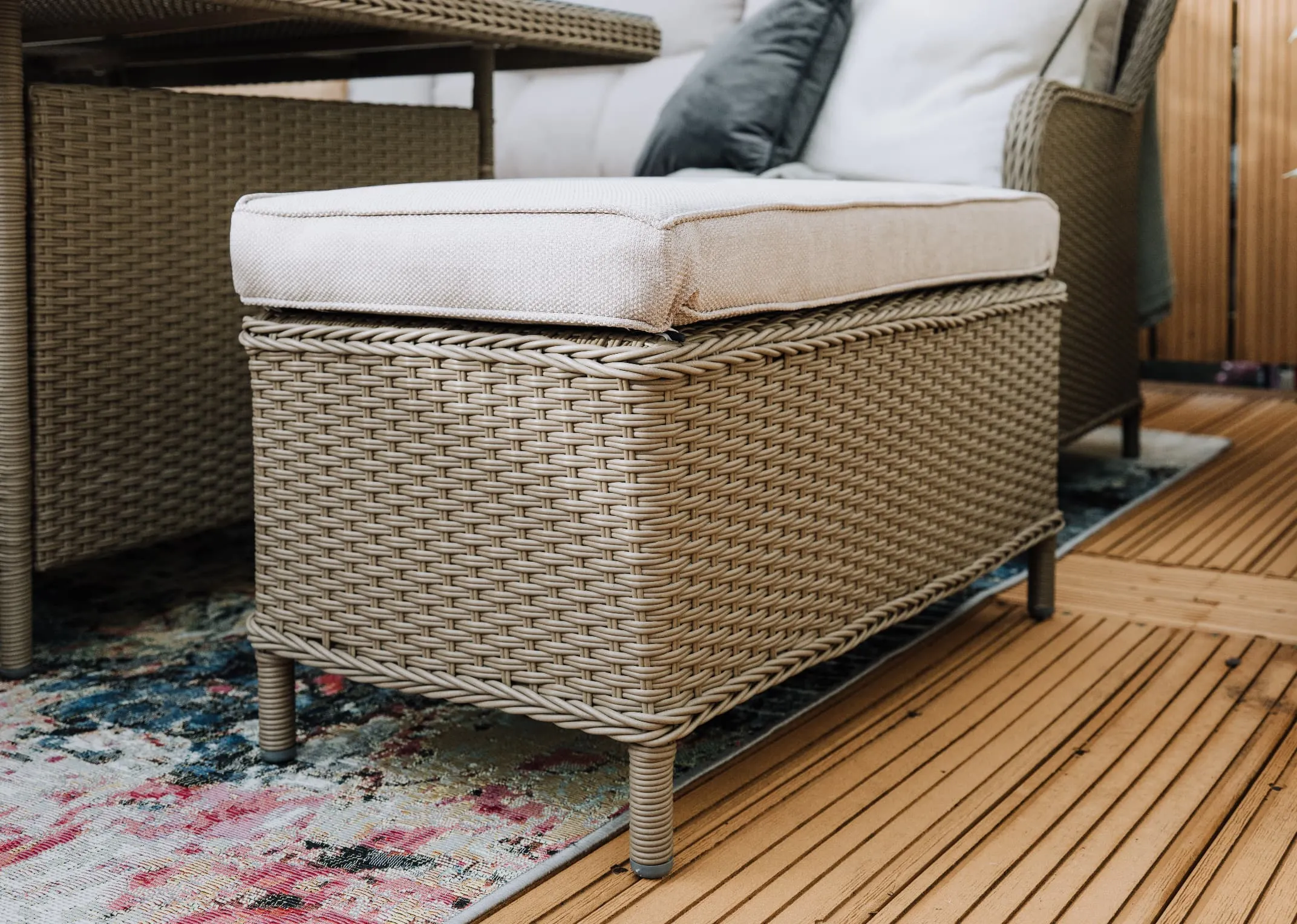 A wicker corner garden sofa with a square dining table & 2 ottoman benches from EZ Livings Marbella range.