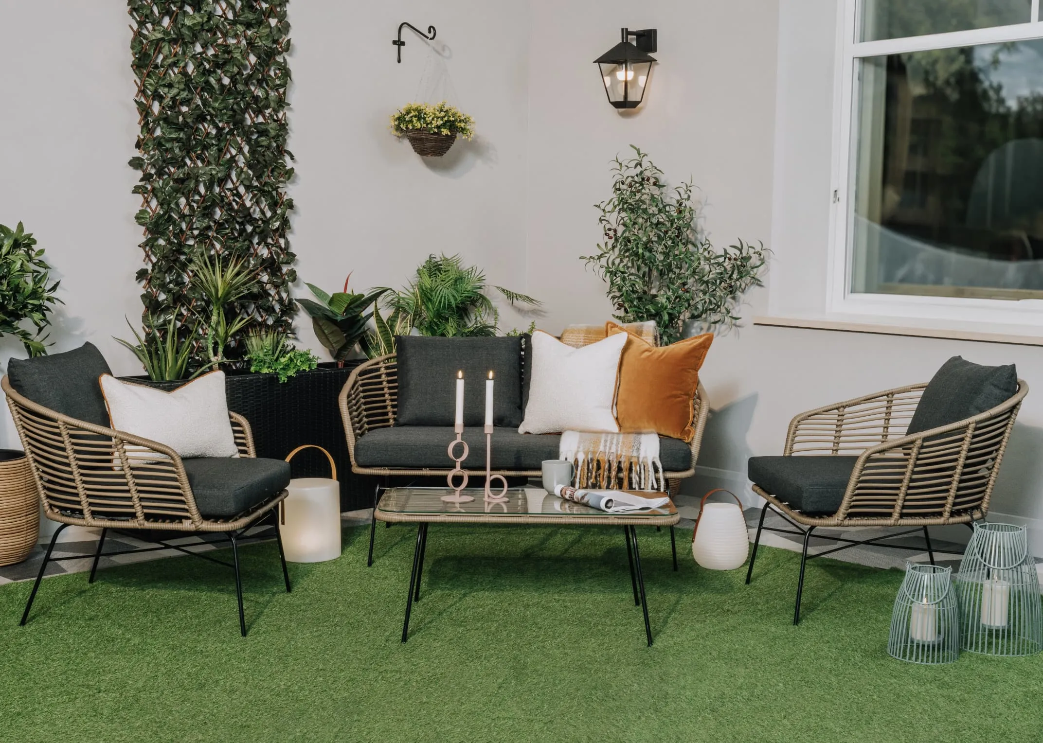 A lifestyle image of the Tangier Garden set in an outdoor setting with cushions
