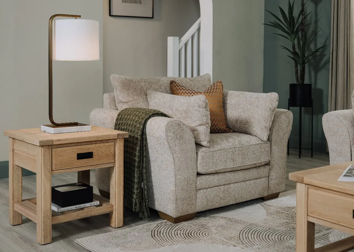 A lifestyle image of the Skyline armchair with Albany side table with Pheonix table lamp.
