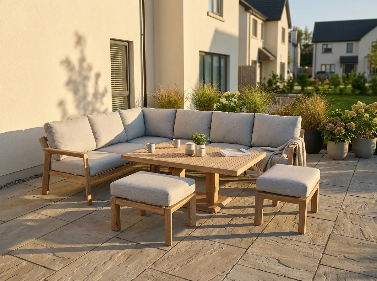 A lifestyle image of the Bordeaux Corner garden set with 2 ottomans in a small garden outside a house in an estate.