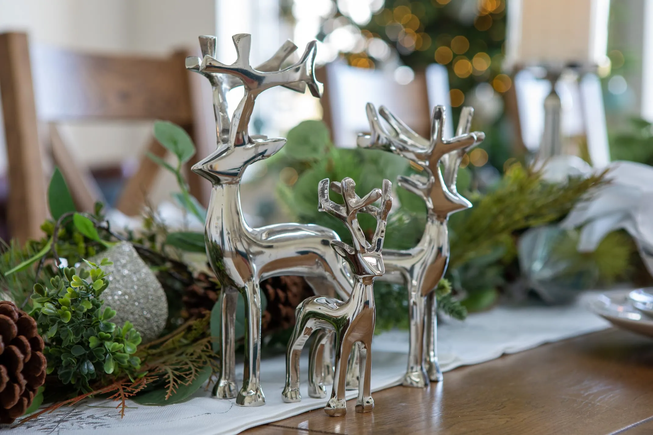 A lifestyle image of the Set of reindeers with garlands on mantle