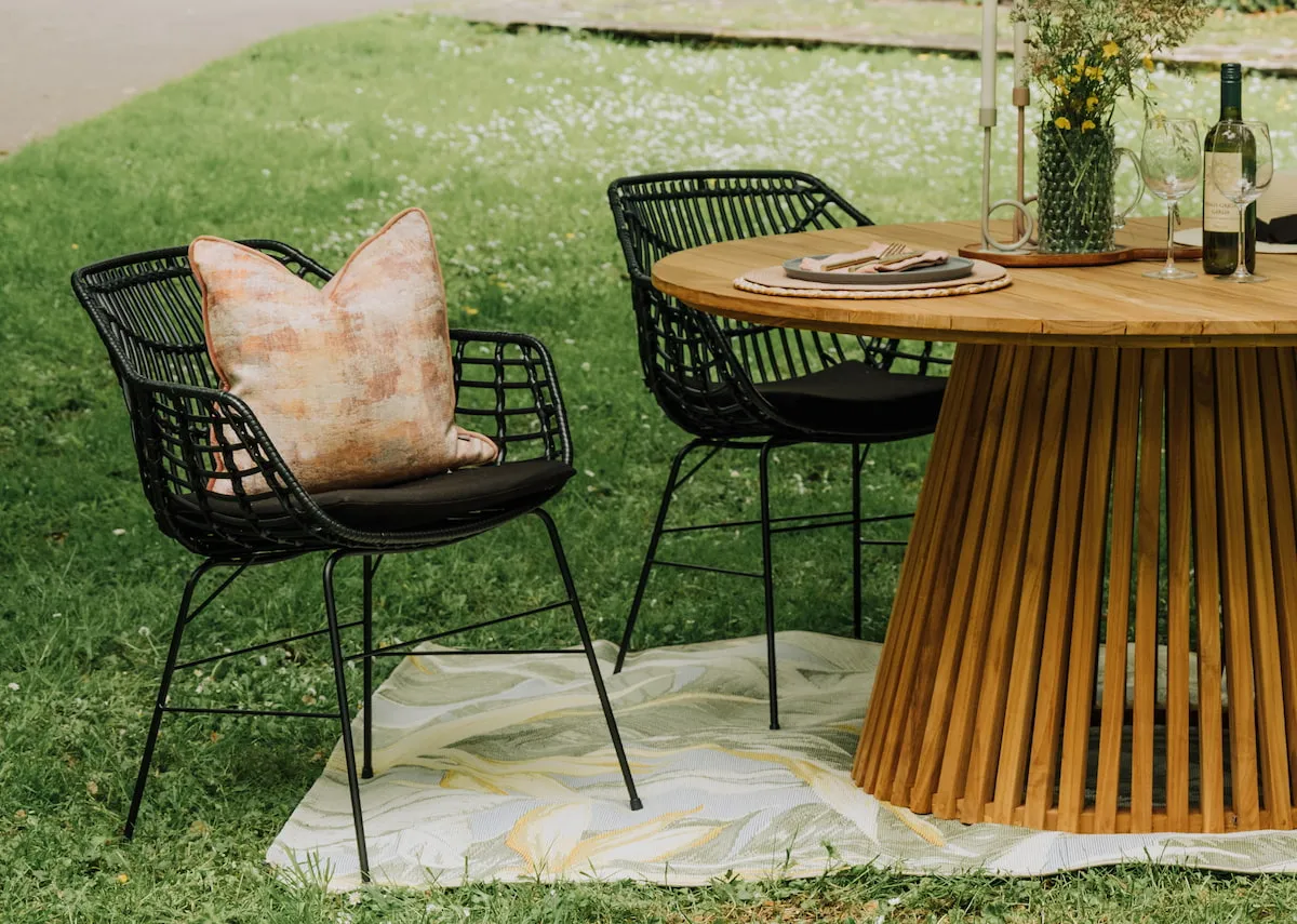 A black wicker dining chair from EZ Livings Porto range. Front view of padded seat cushion removeable.