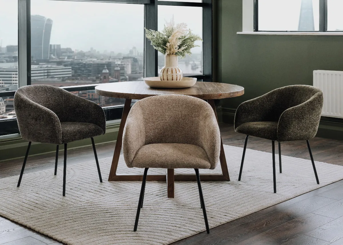 A lifestyle image of the Rotterdam beige chair with green and grey and Ladder round table