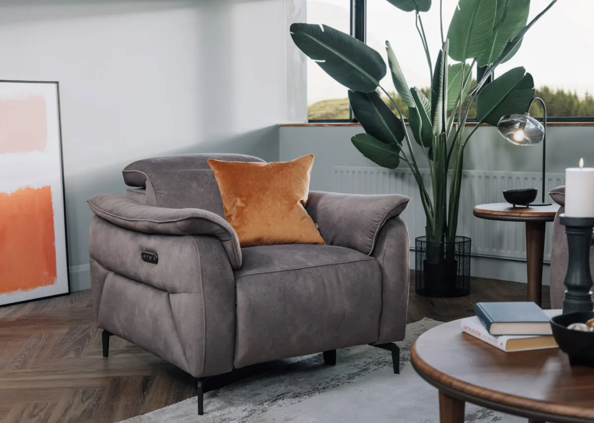 A lifestyle image of the Carlton recliner with gold cushion and echo coffee table