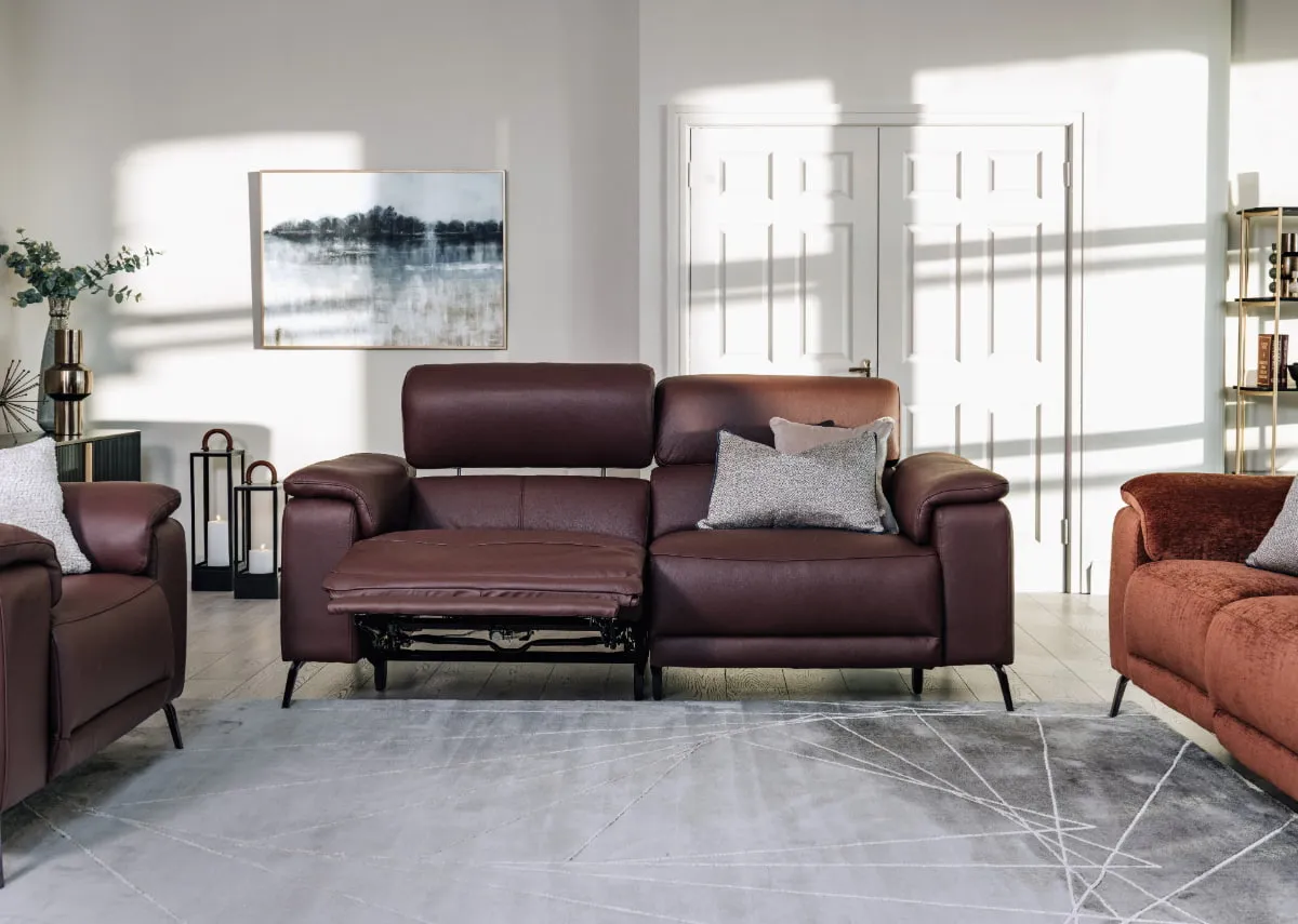 A lifestyle image of the Paige 3 seater recliner with avery rug and Adrift