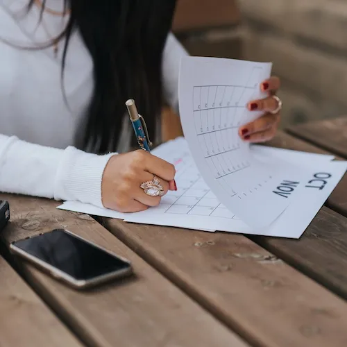 Woman making a list from EZ Living Furniture.