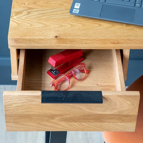 Mia desk open with glasses and stapler.