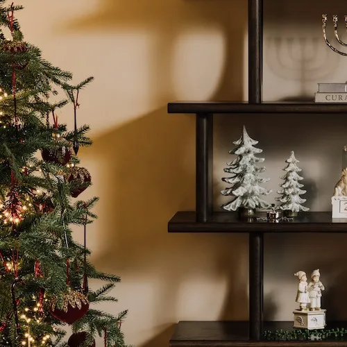 Christmas ornaments and figurines displayed on a shelf.