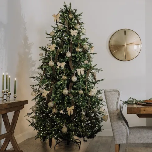 Rockefeller Tree decorated with taupe velvet bows and other tree ornaments.