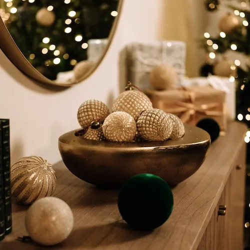Multiple Christmas baubles on display in a decorative bowl at EZ Living Furniture.