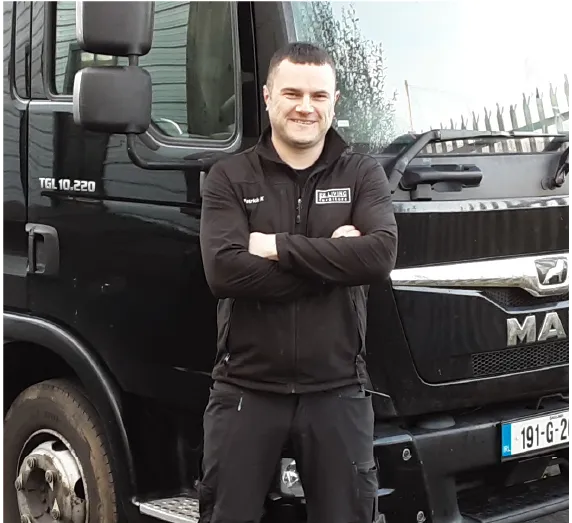 EZ Living Furniture delivery driver beside a company truck