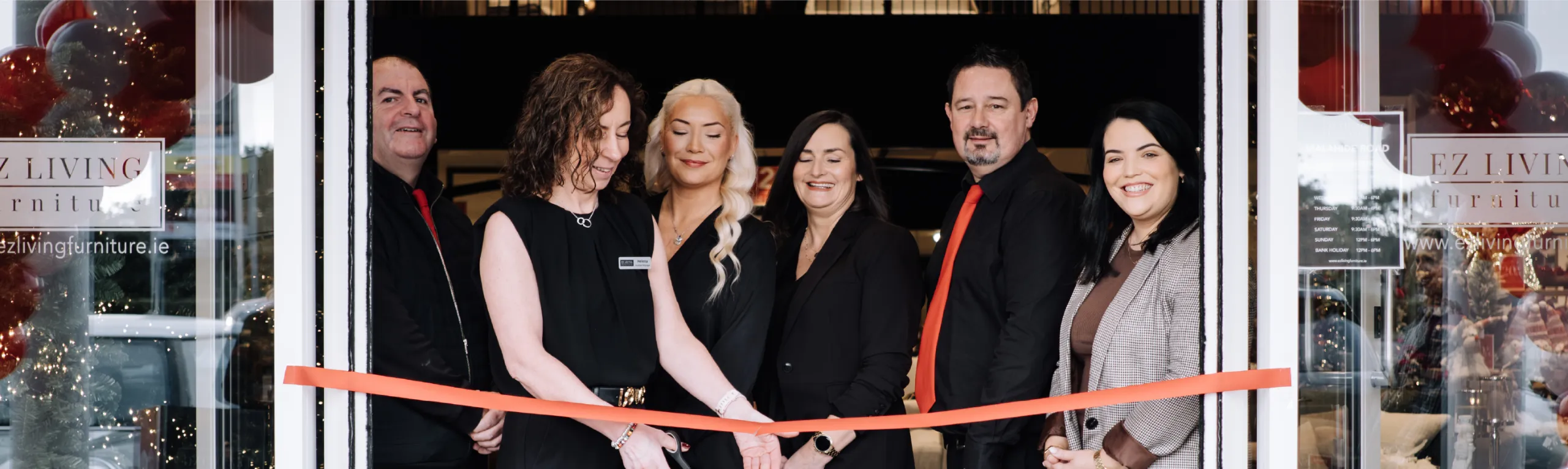 EZ Living Furniture team cutting the ribbon at a new store opening