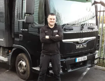 Patrick beside his delivery truck